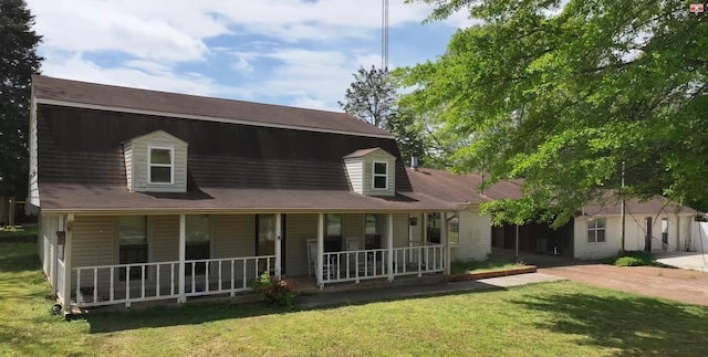 view of front of home featuring covered porch and a front yard