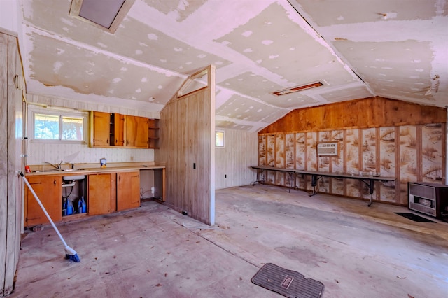 kitchen with brown cabinets, lofted ceiling, light countertops, open shelves, and a sink