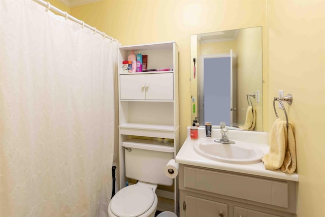 bathroom with vanity, toilet, and crown molding