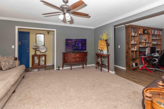 living room with crown molding, ceiling fan, and a textured ceiling