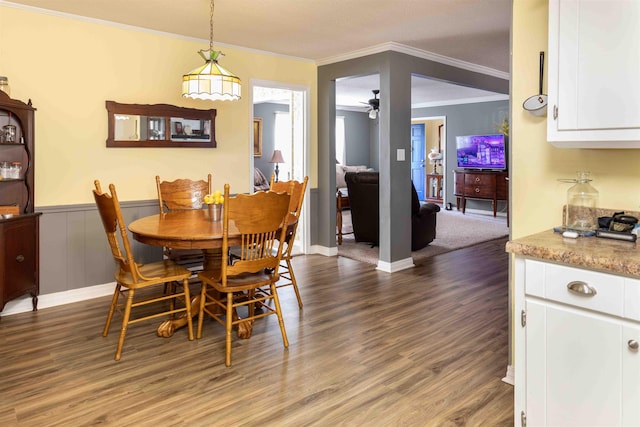 dining room with hardwood / wood-style flooring, ceiling fan, and ornamental molding