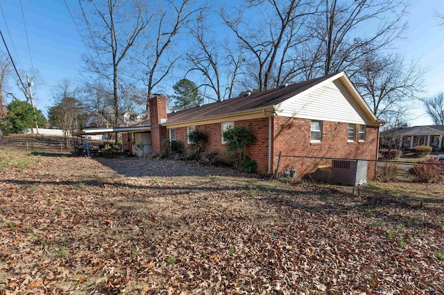 view of side of home with a carport