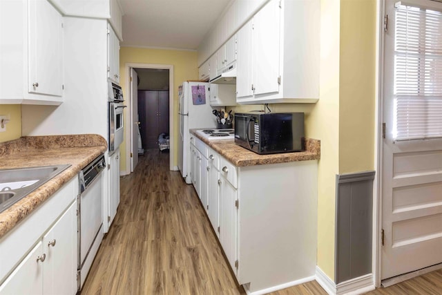 kitchen featuring white appliances, light hardwood / wood-style flooring, and white cabinetry