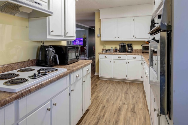 kitchen featuring light hardwood / wood-style floors, white gas stovetop, white cabinetry, and extractor fan