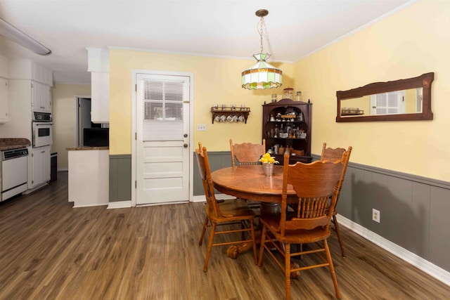 dining space featuring ornamental molding and dark wood-type flooring