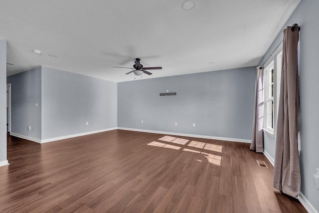 spare room featuring dark hardwood / wood-style floors and ceiling fan