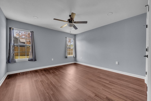 spare room with wood-type flooring and ceiling fan