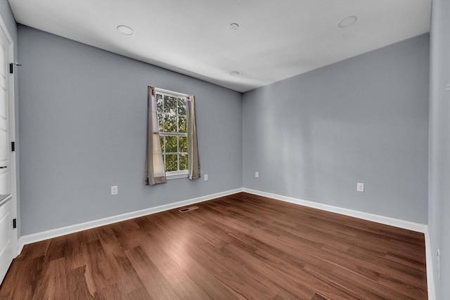 empty room with wood-type flooring