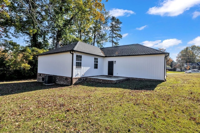 back of house with a yard, cooling unit, and a patio