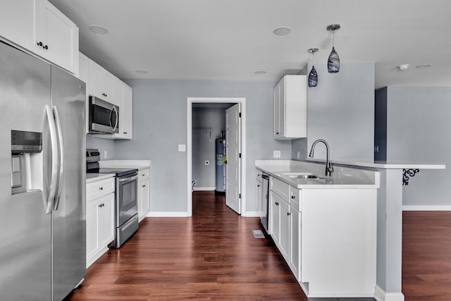 kitchen featuring white cabinets, stainless steel appliances, and hanging light fixtures