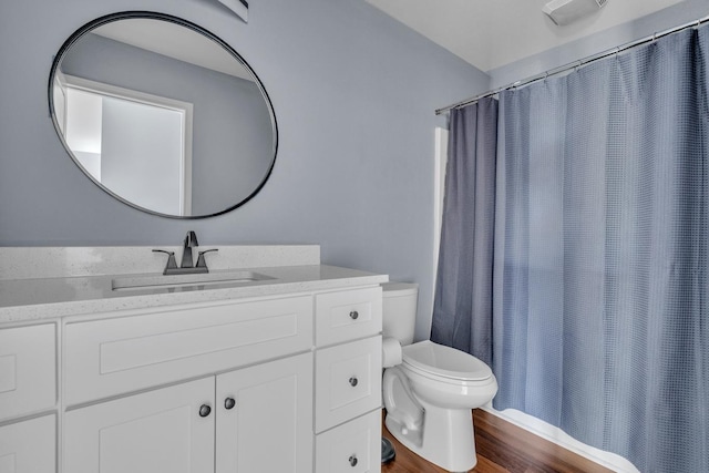 bathroom with toilet, vanity, a shower with shower curtain, and hardwood / wood-style flooring