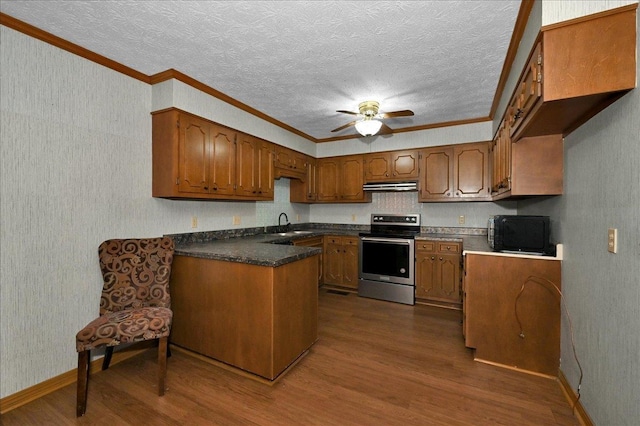  - kitchen with stainless steel electric stove, black microwave, dark wood-style floors, under cabinet range hood, and brown cabinets