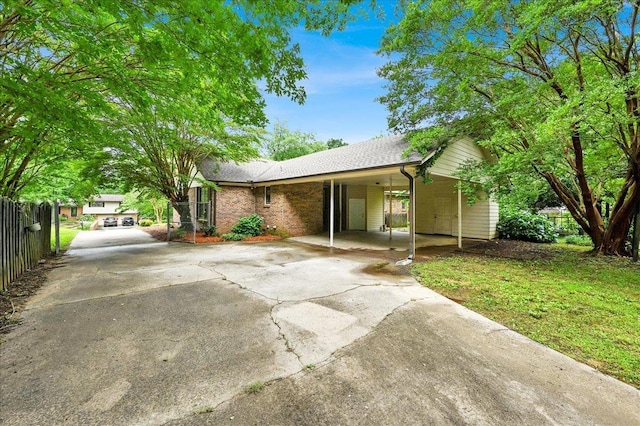  - single story home featuring driveway and a carport