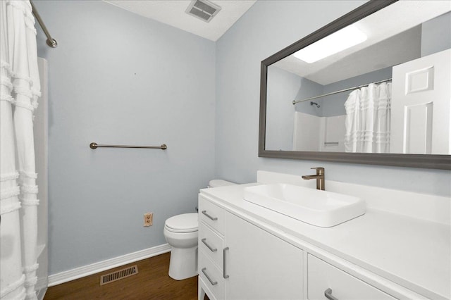  - full bath with vanity, toilet, wood finished floors, baseboards, and a shower with shower curtain