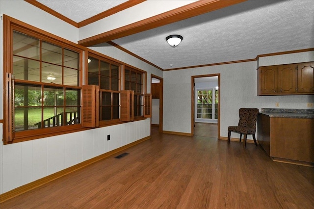  - living area featuring crown molding, dark wood finished floors, a textured ceiling, and baseboards