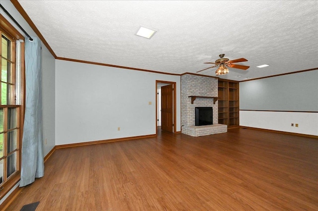  - unfurnished living room featuring wood finished floors, ceiling fan, a fireplace, a textured ceiling, and baseboards