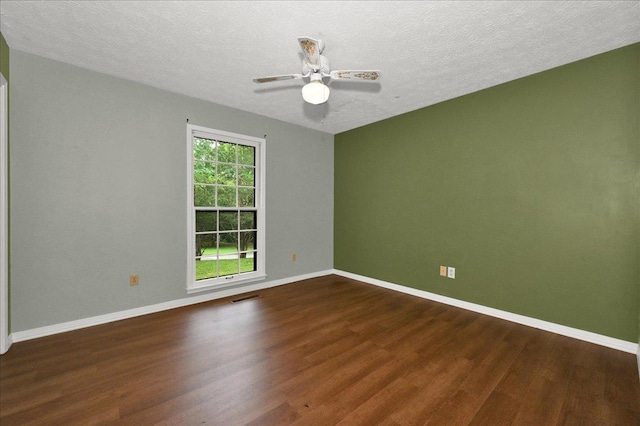  - spare room featuring wood finished floors, baseboards, a ceiling fan, and a textured ceiling