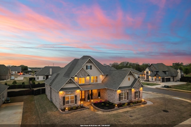  - view of front of property with concrete driveway, stone siding, a porch, and a shingled roof