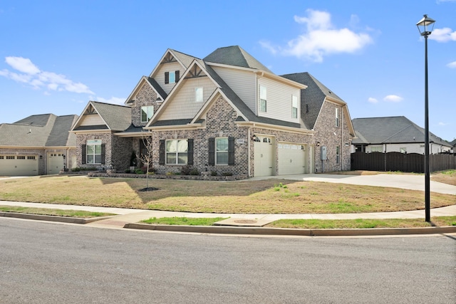craftsman-style home with a front yard, an attached garage, fence, concrete driveway, and brick siding