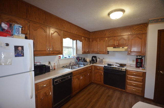  - kitchen featuring a textured ceiling, sink, dark wood-type flooring, and black appliances