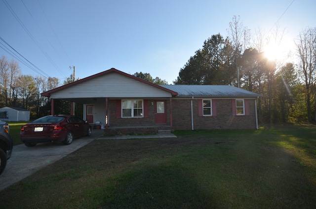 single story home featuring a carport and a front lawn