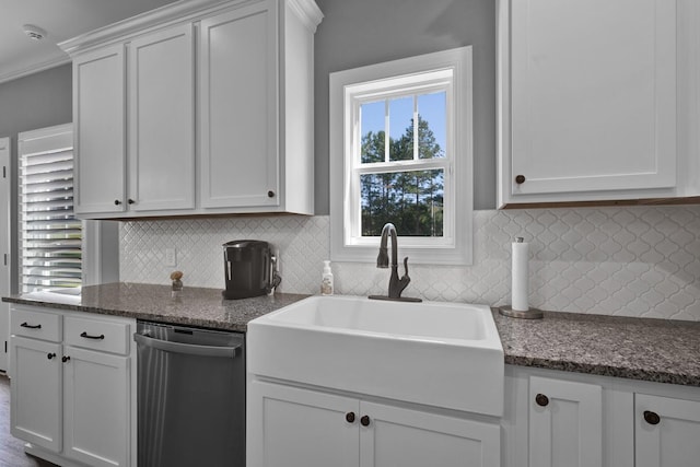 kitchen featuring dishwasher, backsplash, white cabinets, sink, and plenty of natural light