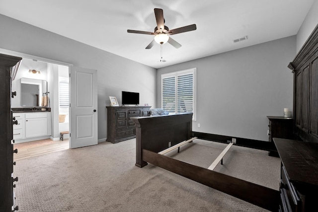 carpeted bedroom with ceiling fan and connected bathroom