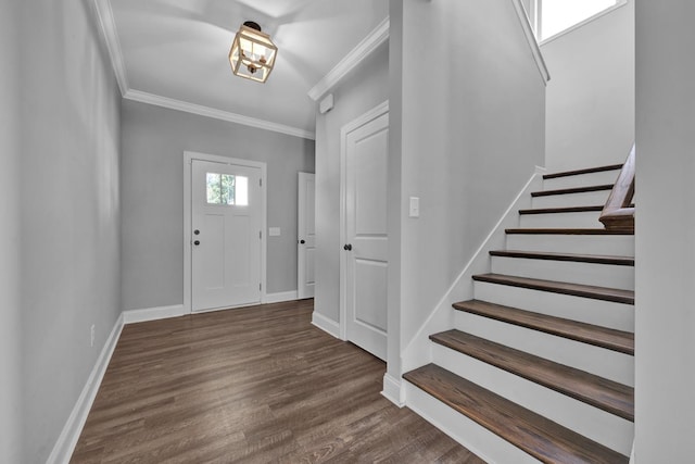 foyer entrance featuring dark hardwood / wood-style flooring and ornamental molding