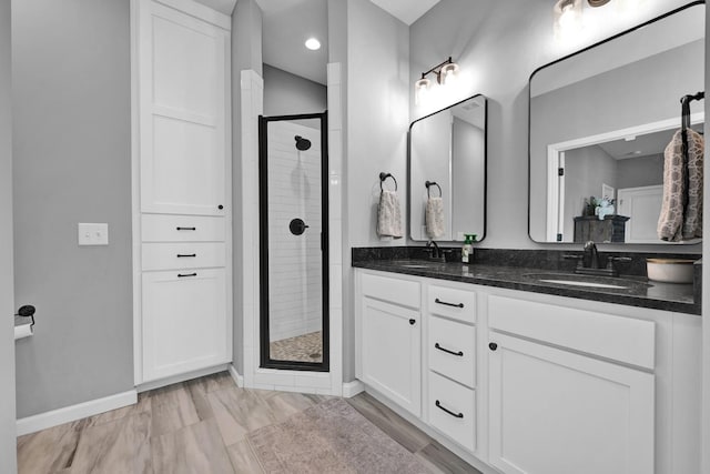 bathroom featuring vanity and a shower with shower door