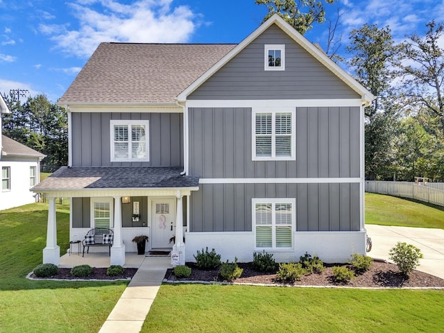 view of front of house featuring covered porch and a front lawn