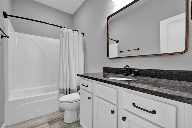 full bathroom with vanity, shower / bath combination with curtain, and toilet