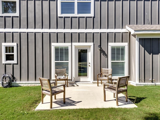 rear view of house with a patio and a lawn