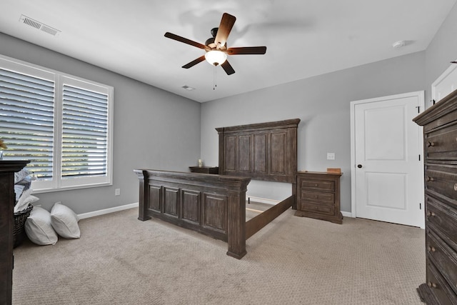 bedroom featuring light colored carpet and ceiling fan