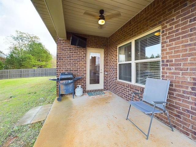 view of patio with area for grilling and ceiling fan