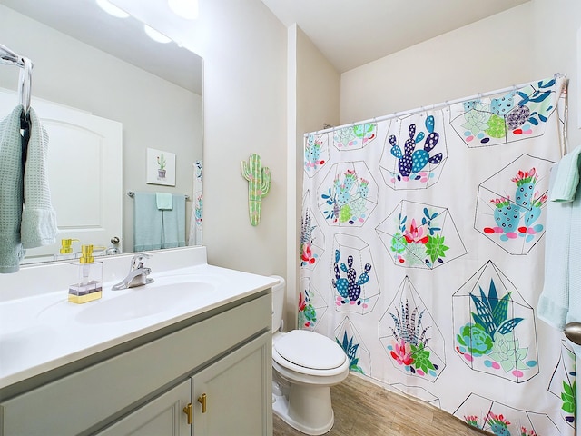 bathroom with a shower with shower curtain, wood-type flooring, vanity, and toilet