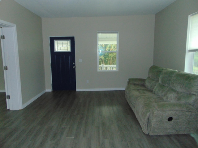 unfurnished living room featuring dark hardwood / wood-style floors