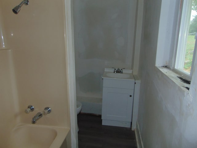 full bathroom featuring vanity, hardwood / wood-style flooring, toilet, and tub / shower combination