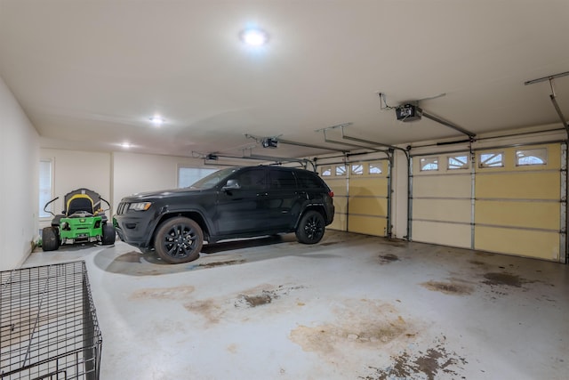 garage featuring a garage door opener and a carport