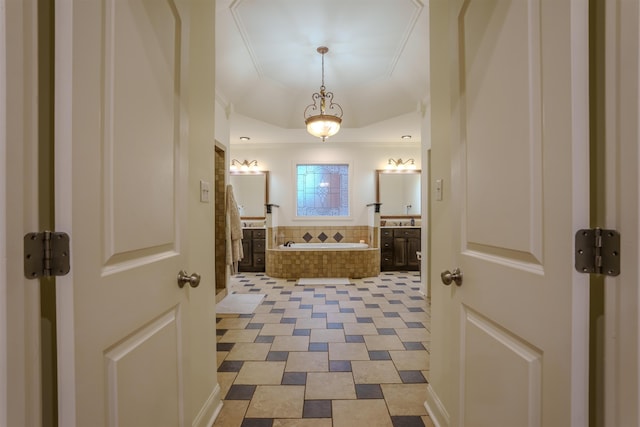 bathroom with vanity and tiled tub