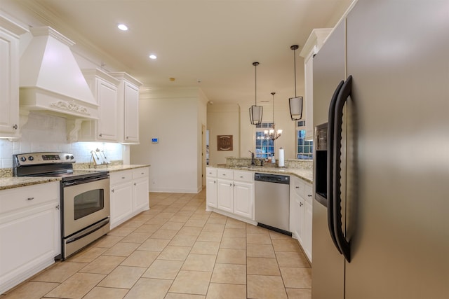 kitchen with premium range hood, light stone counters, white cabinets, and appliances with stainless steel finishes