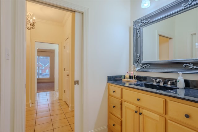 bathroom with tile patterned flooring, vanity, and ornamental molding