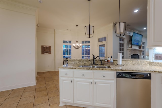 kitchen featuring sink, light tile patterned floors, stainless steel dishwasher, pendant lighting, and white cabinets