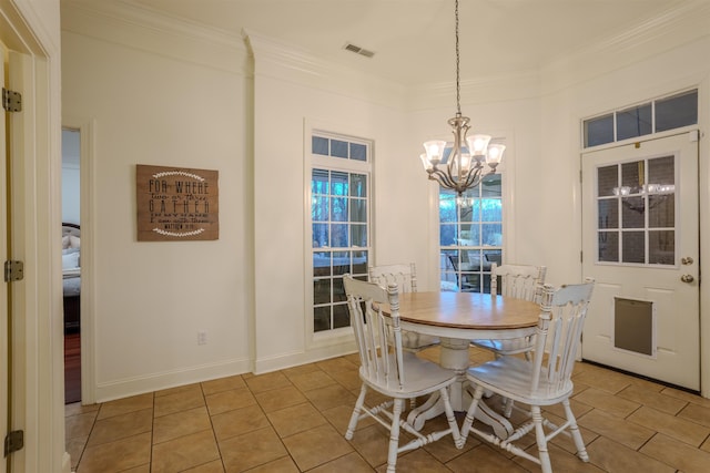 tiled dining space with an inviting chandelier and crown molding