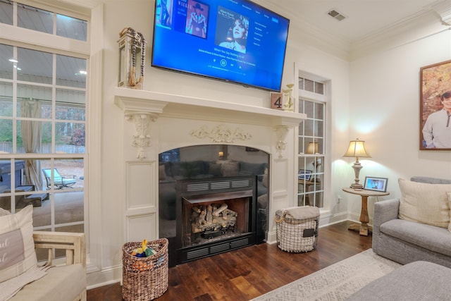 living area featuring dark hardwood / wood-style floors and ornamental molding