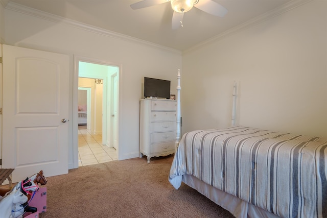 carpeted bedroom featuring ceiling fan and ornamental molding