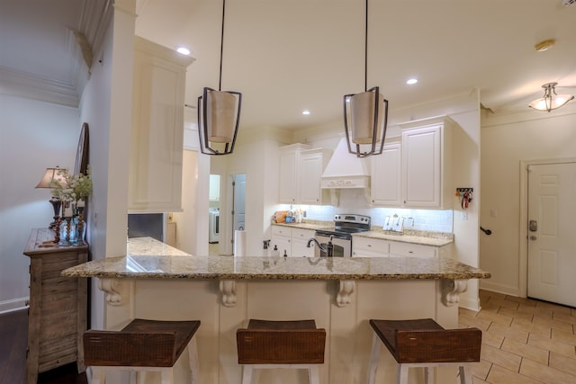 kitchen with kitchen peninsula, pendant lighting, white cabinets, and stainless steel range with electric cooktop