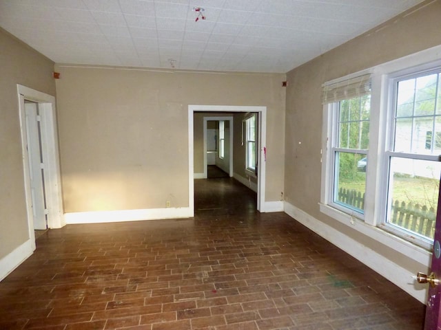 spare room featuring baseboards