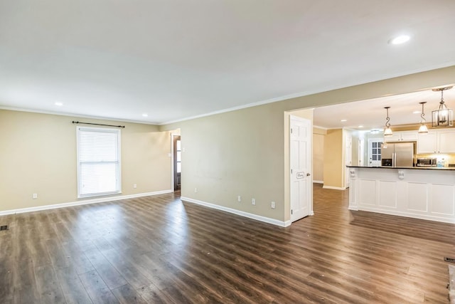 unfurnished living room featuring crown molding and dark wood-type flooring