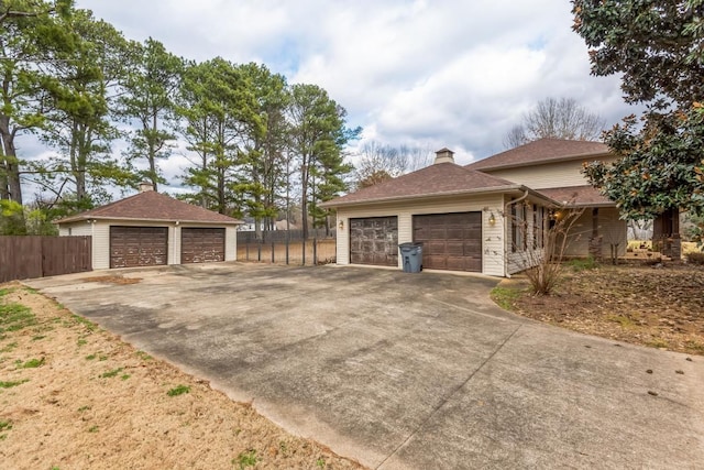 view of side of property featuring an outbuilding and a garage