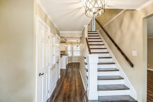 stairs with hardwood / wood-style flooring, ornamental molding, and a chandelier